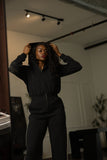 Tall black track jumpsuit hood detail
